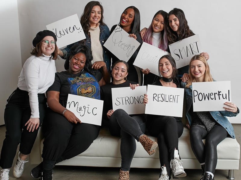 a group of women holding signs