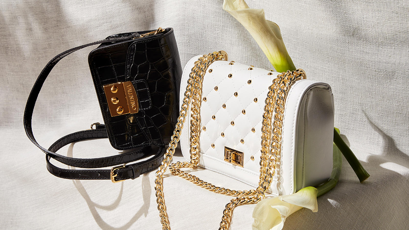 a black and white purse with a flower in it
