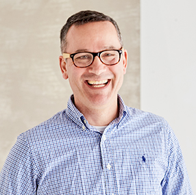 a person wearing glasses and a blue shirt