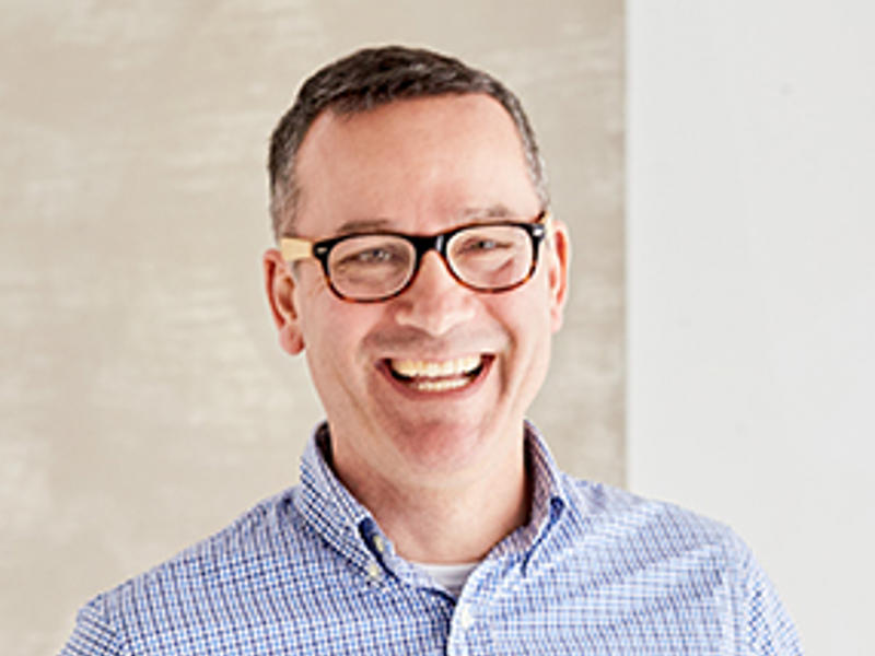 a person wearing glasses and a blue shirt