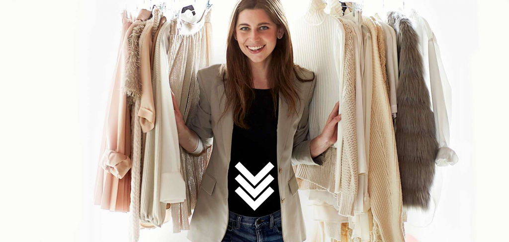 a person standing in front of a rack of clothes