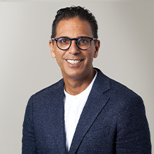 a person wearing glasses and a blue jacket