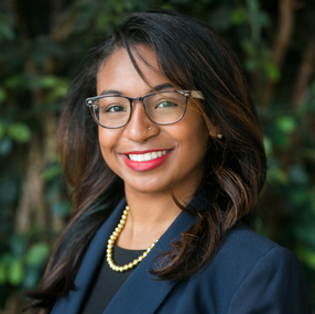 a person wearing glasses and a blue jacket