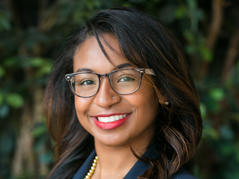 a person wearing glasses and a blue jacket